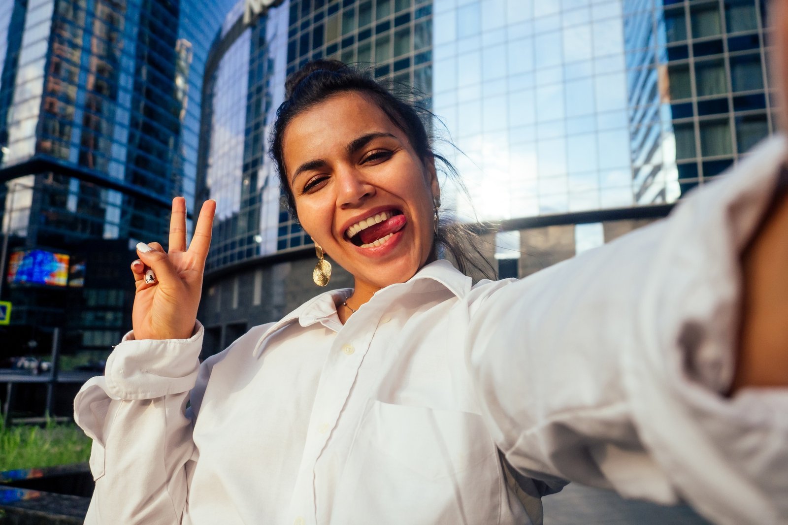 beautiful india girl making selfie on the background of the business center Moscow sity
